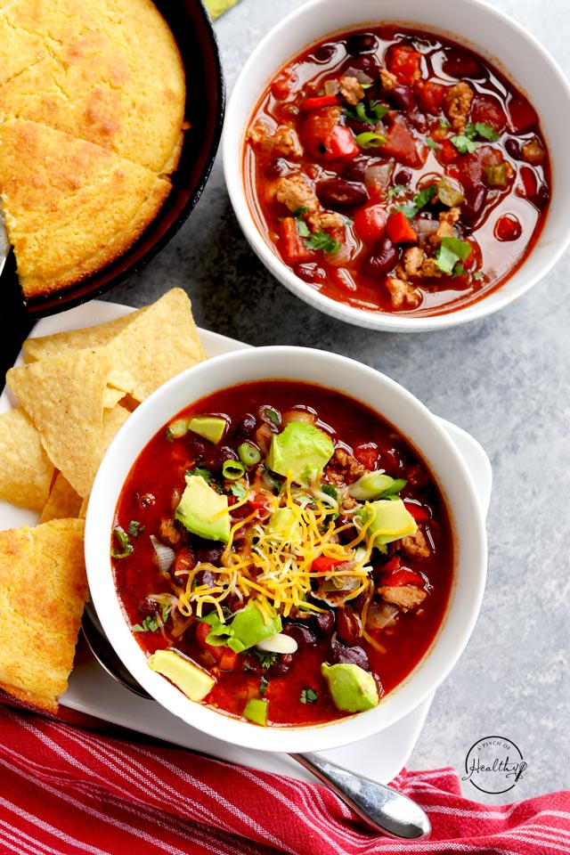 Healthy turkey chili with diced avocado and cheese