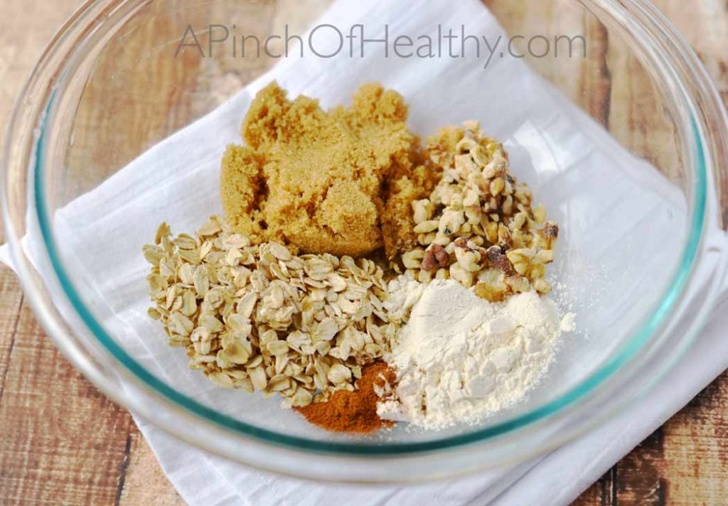 brown sugar, white sugar, oats cinnamon and nuts in a clear mixing bowl