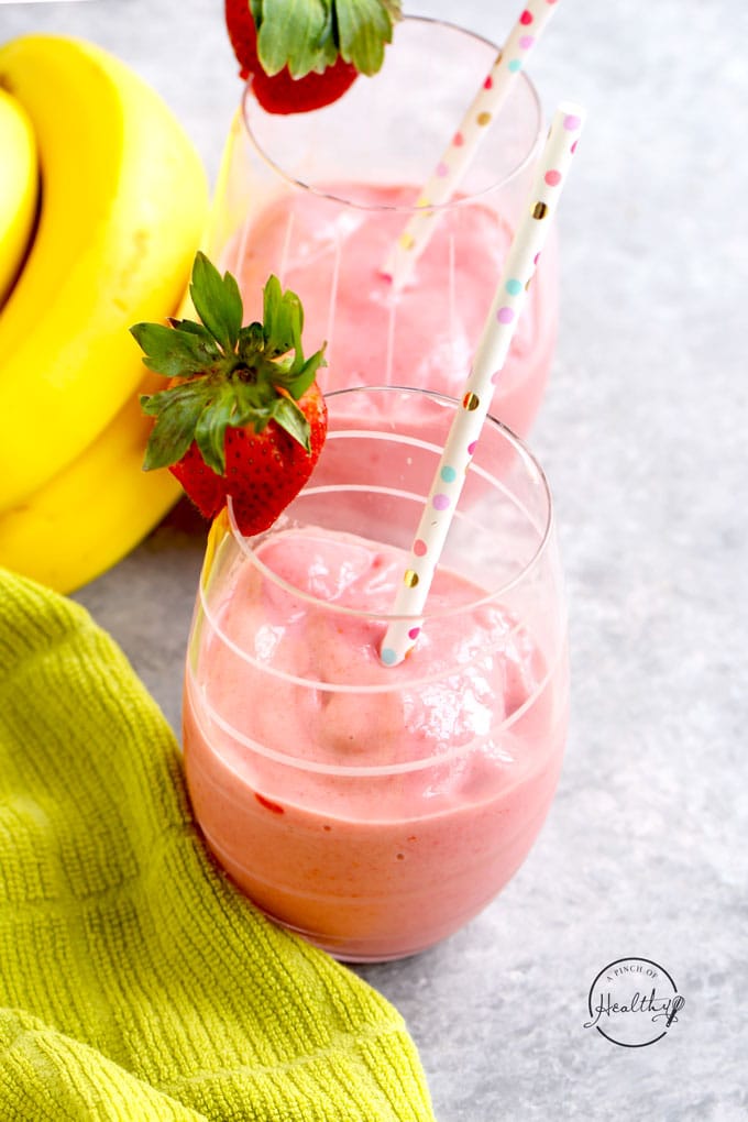 Strawberry banana smoothie in cute glass with polka dot straw