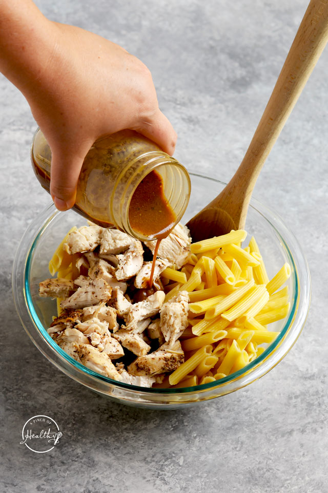 chicken and pasta with balsamic vinaigrette dressing poured on top
