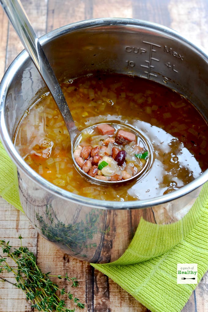 ladle dipping out ham and 15 bean soup from an Instant Pot