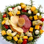 This antipasto Christmas wreath is the perfect easy appetizer for any holiday party, and you don't even have to cook anything. Just pick your favorite meats, cheeses and/ or veggies and assemble. | APinchOfHealthy.com