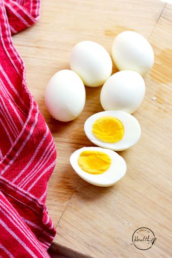 hard boiled eggs on cutting board with red towel