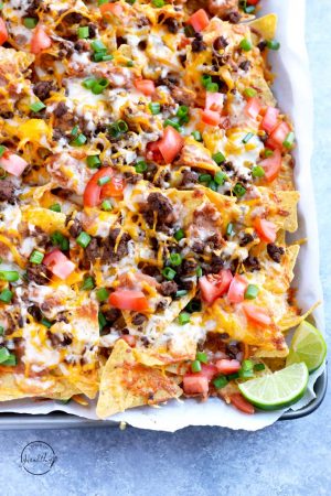 epic beef nachos supreme with lime slices