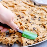 Peanut butter chocolate chip cookie cake with m&ms and buttercream icing - heart shaped for Valentines Day