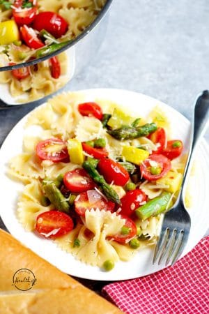 Pasta primavera with squash, asparagus, shallot, garlic, tomatoes
