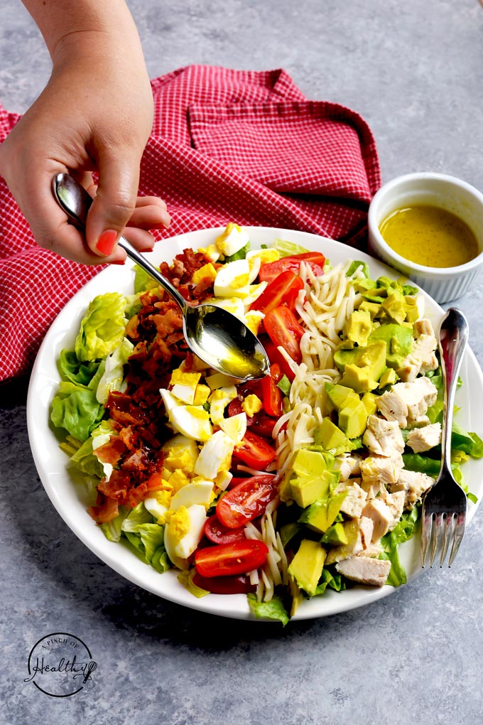 Cobb salad chicken bacon avocado, cheese, tomatoes, eggs, lemon and olive oil