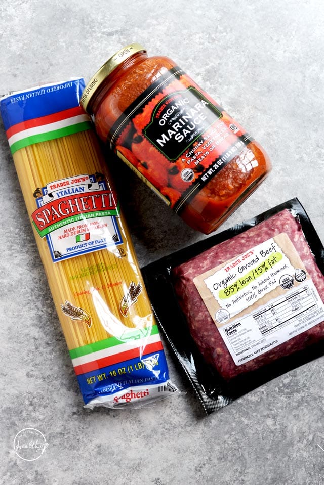 Trader Joe's spaghetti sauce, ground beef and spaghetti on a gray table