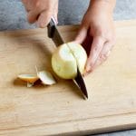 slicing onion in half