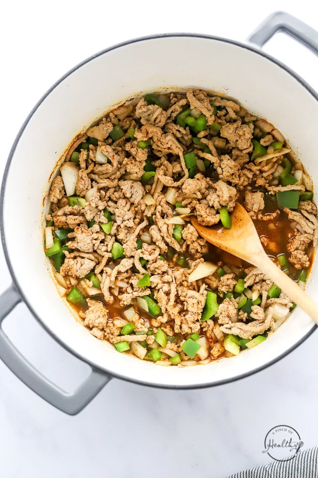 cooking meat and veggies in a pot