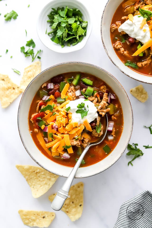 healthy turkey chili in a bowl with cheese