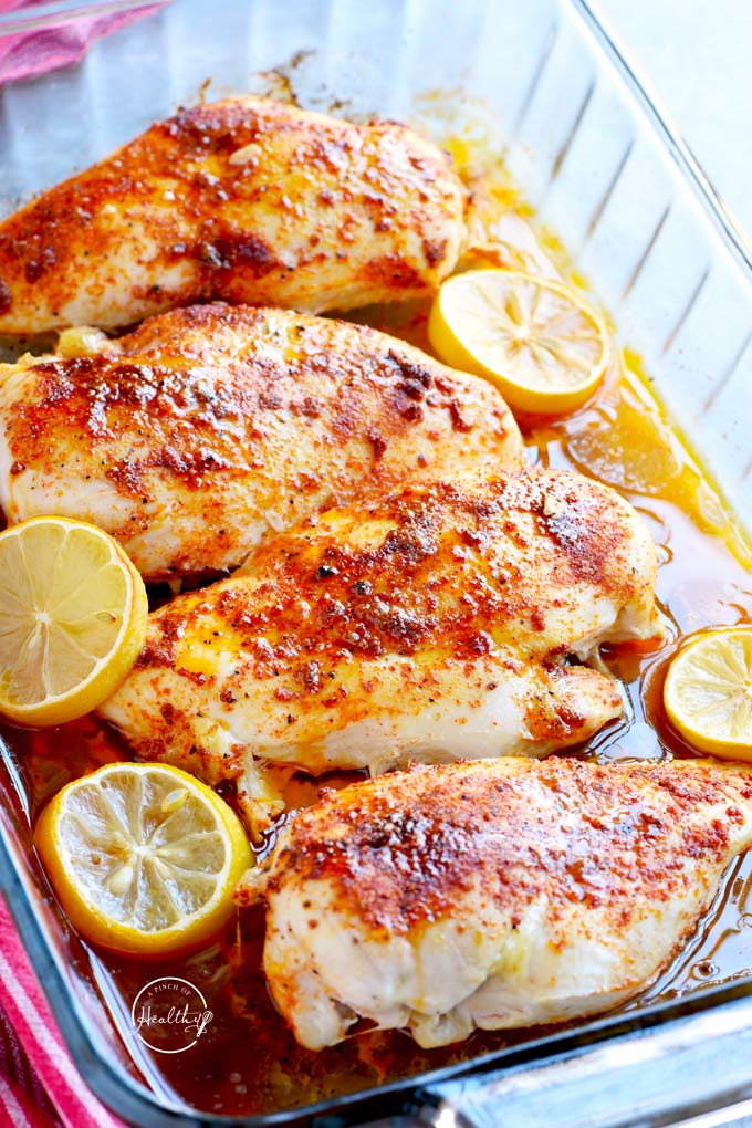 Baked chicken breast with lemon in clear pyrex dish