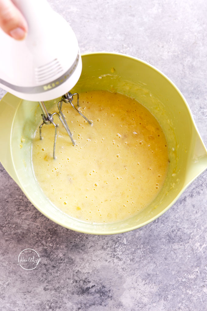 Mixing wet ingredients for banana chocolate chip muffins