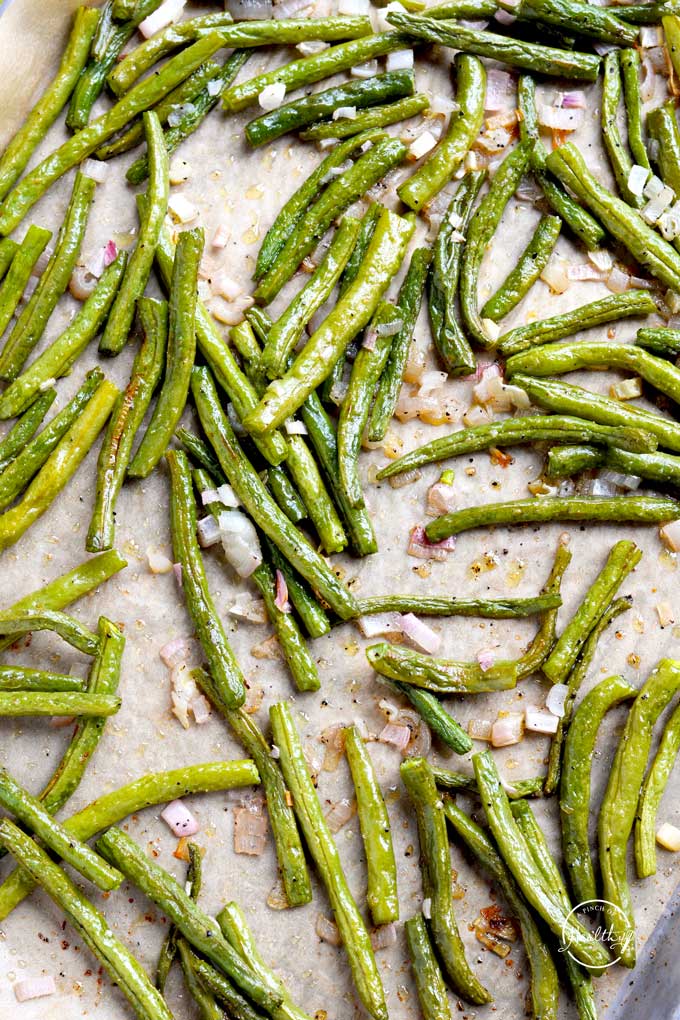 roasted green beans with shallot on a sheet pan from overhead
