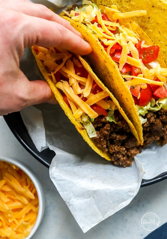 hand grabbing a ground beef taco