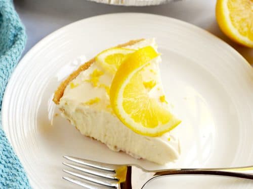 Slice of no bake lemon cheesecake on a white plate