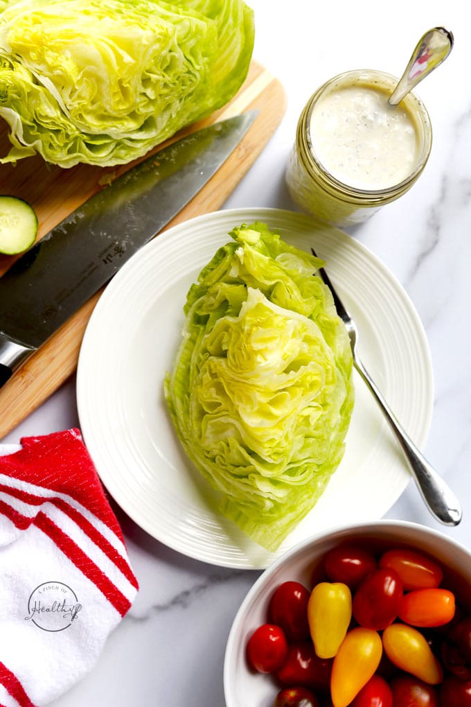 iceberg lettuce wedge on a white plate