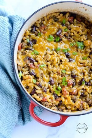 chili mac and cheese in a red pot with blue towel from overhead