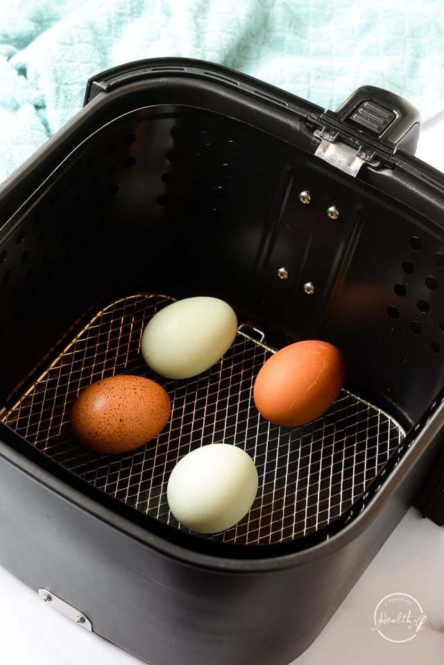blue and brown eggs in shell in air fryer basket