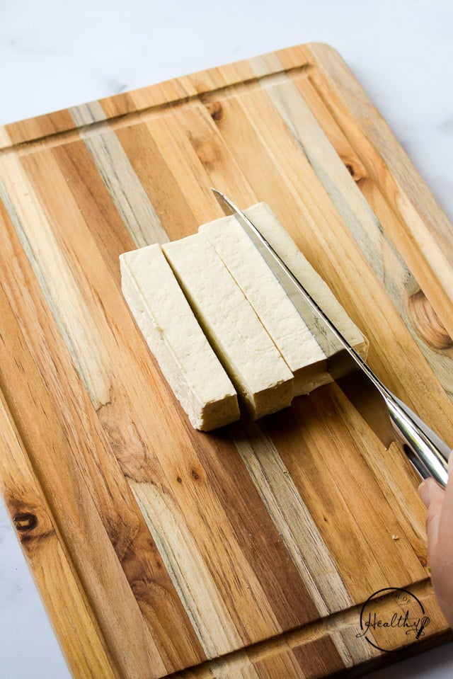 cutting tofu on wood board