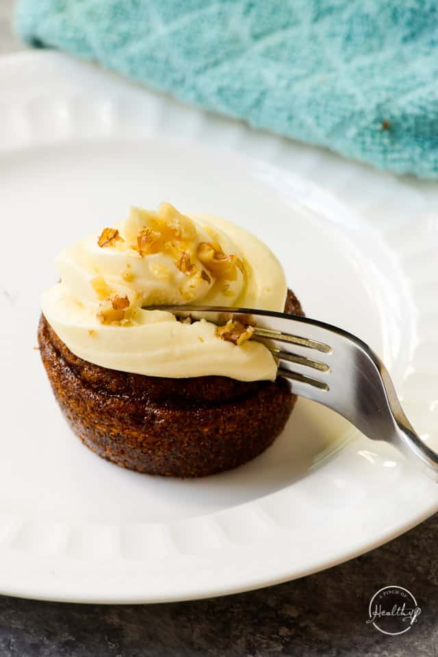fork cutting in to carrot cake cupcake 