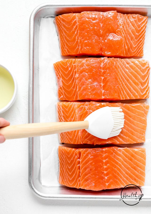 brushing oil on raw fish