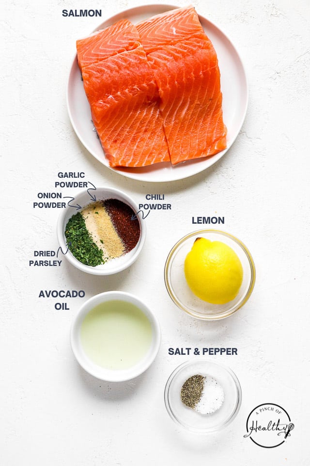 fish, spices, lemon and oil on a white counter top