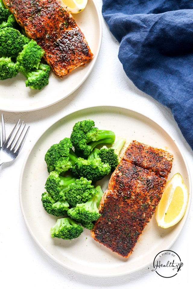 Oven baked salmon on a plate with broccoli overhead