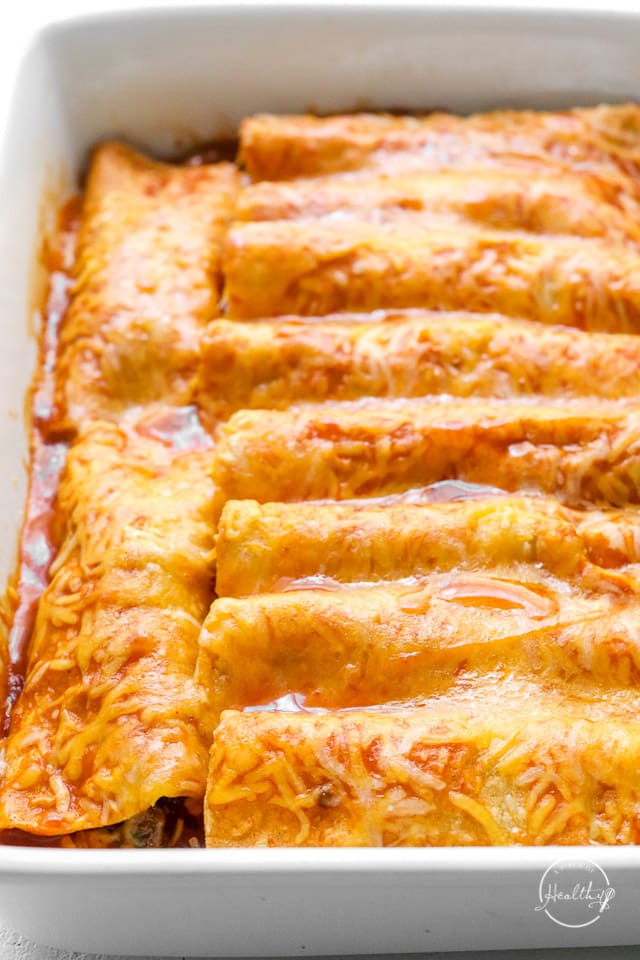 casserole dish of baked enchiladas topped with melted cheese