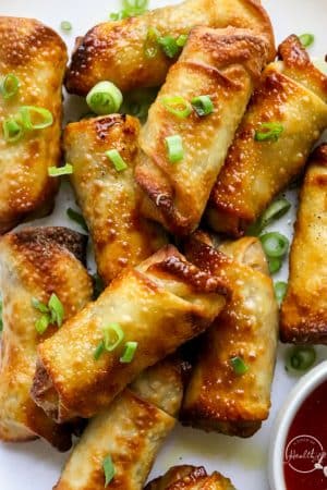 air fryer egg rolls with dipping sauce on white plate