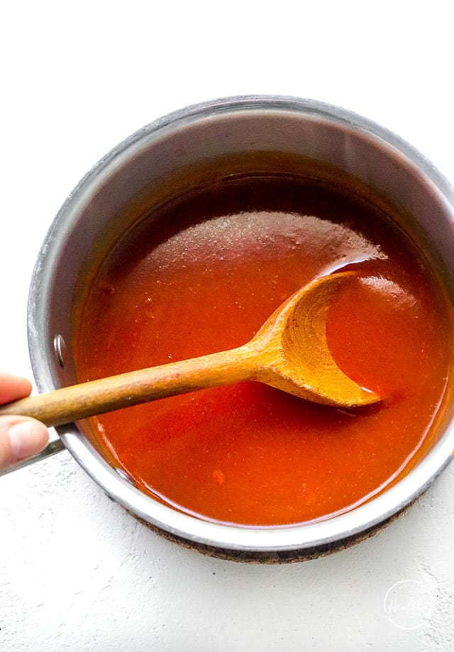 heating red sauce in a small pot
