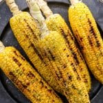 Grilled Corn on the Cob on dark plate with char marks