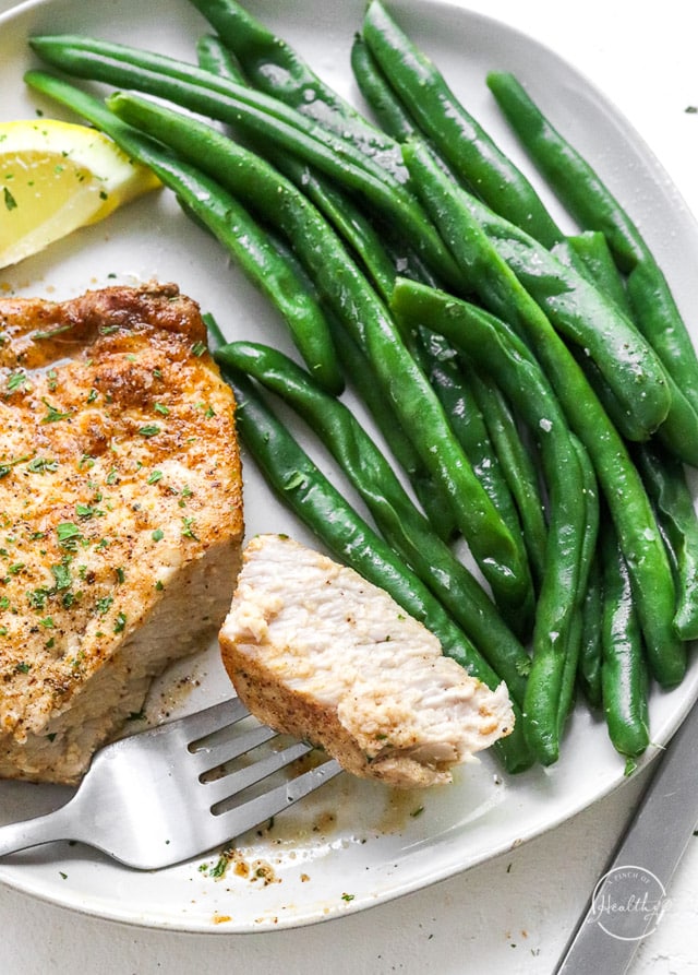 closeup bite of air fryer pork chop on a fork