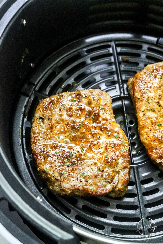 air fryer pork chops closeup in the air fryer basket