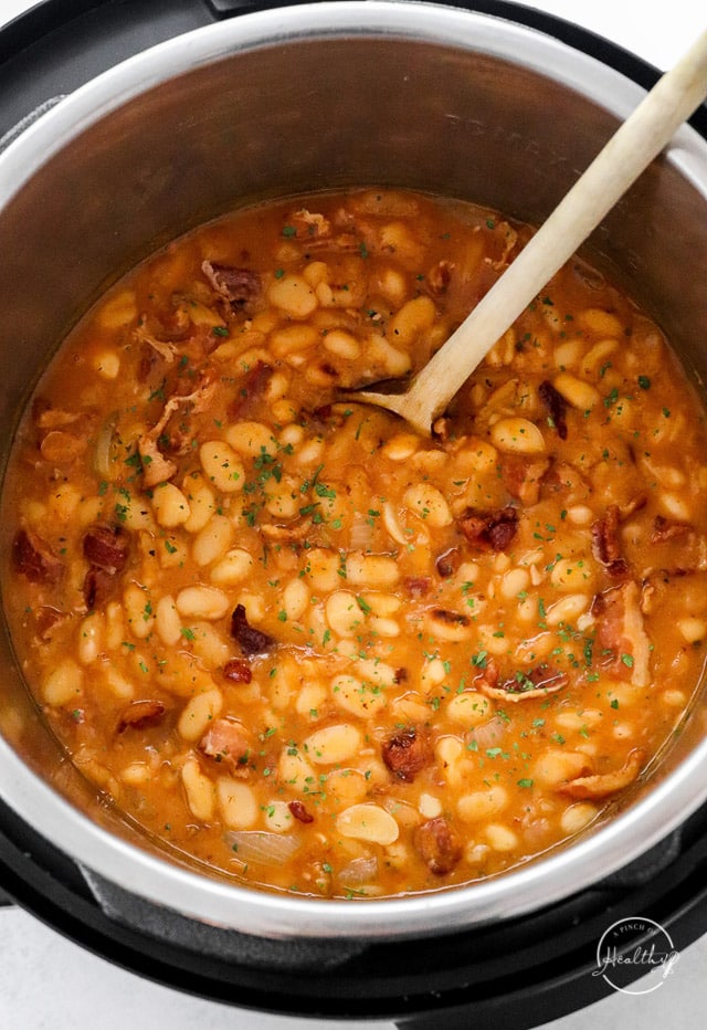 Instant Pot baked beans in the pot with wooden spoon