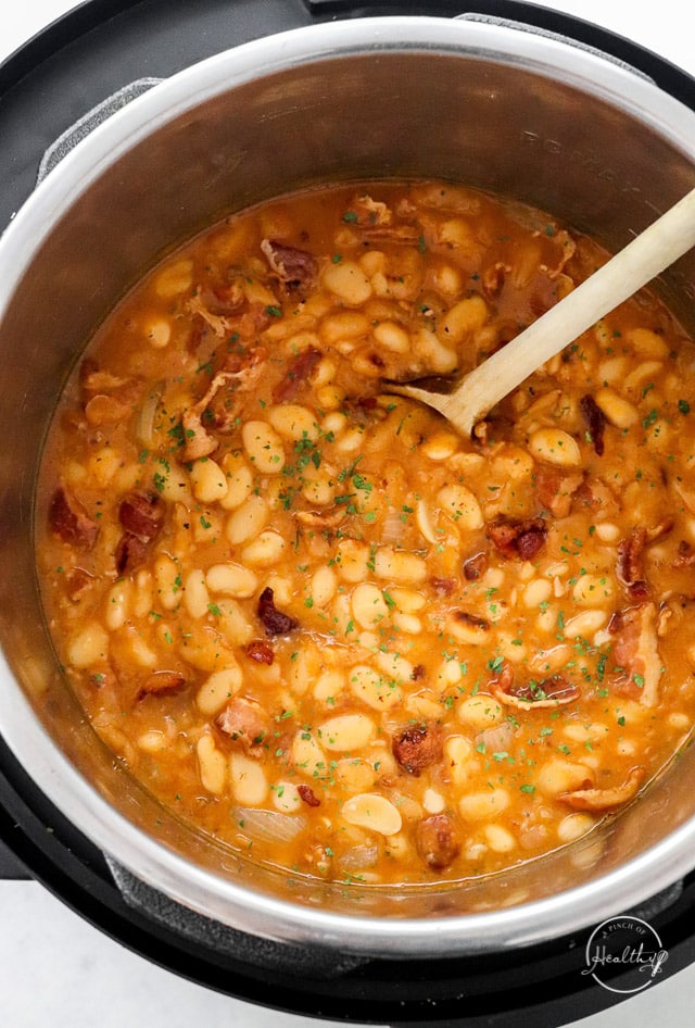 Baked beans in the Instant Pot with wooden spoon