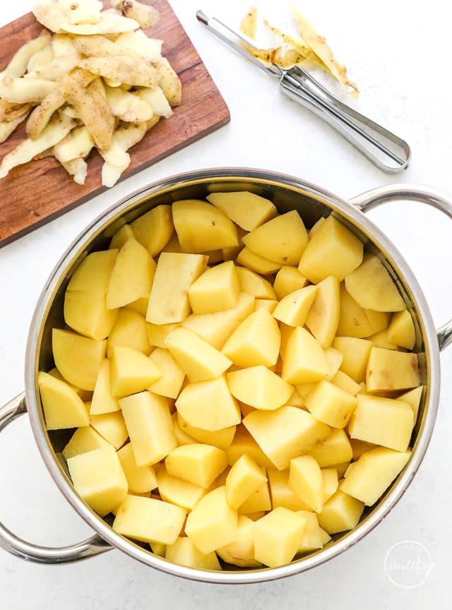 peeled and chopped potatoes in a cooking pot