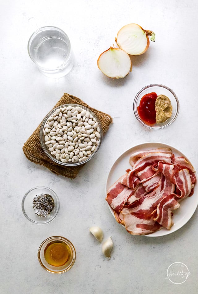 bacon, seasonings and other ingredients on white surface