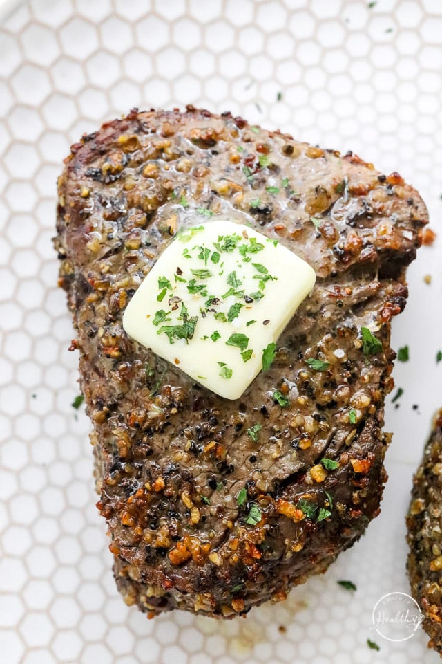 cooked filet steak with herb butter