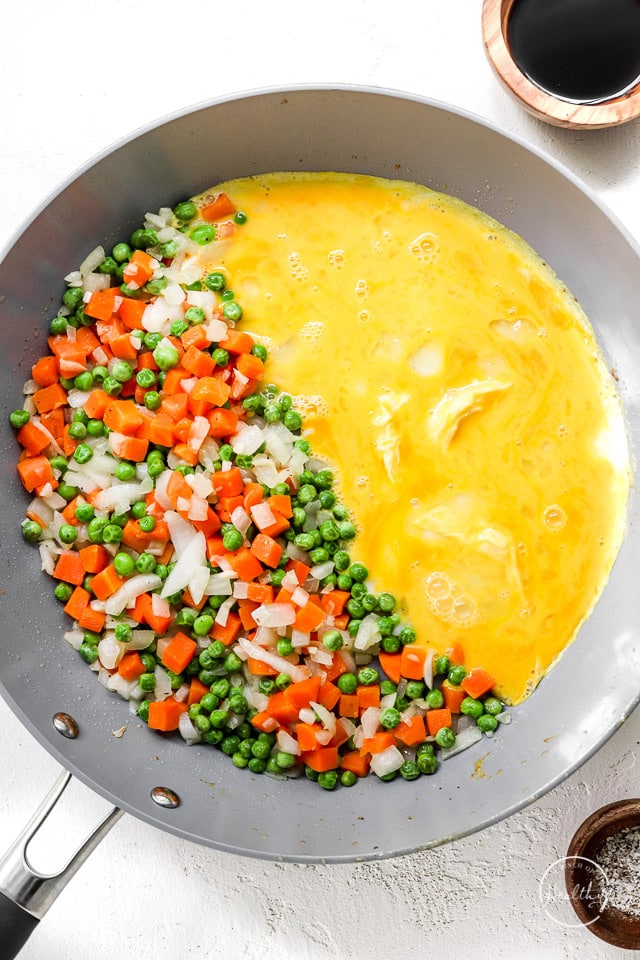 adding eggs to make fried rice