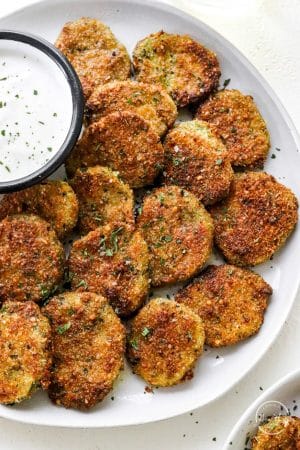 Air fryer pickles on a plate with ranch closeup