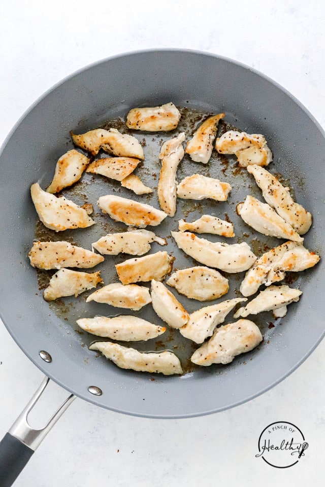 cooking chicken breast pieces in a pan