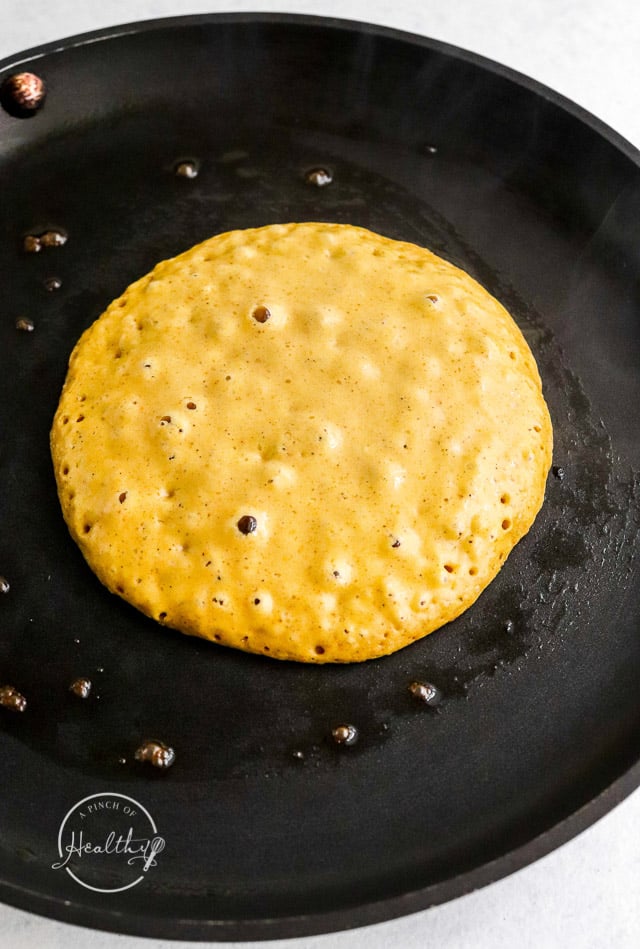 cooking pumpkin pancakes on first side until batter bubbles