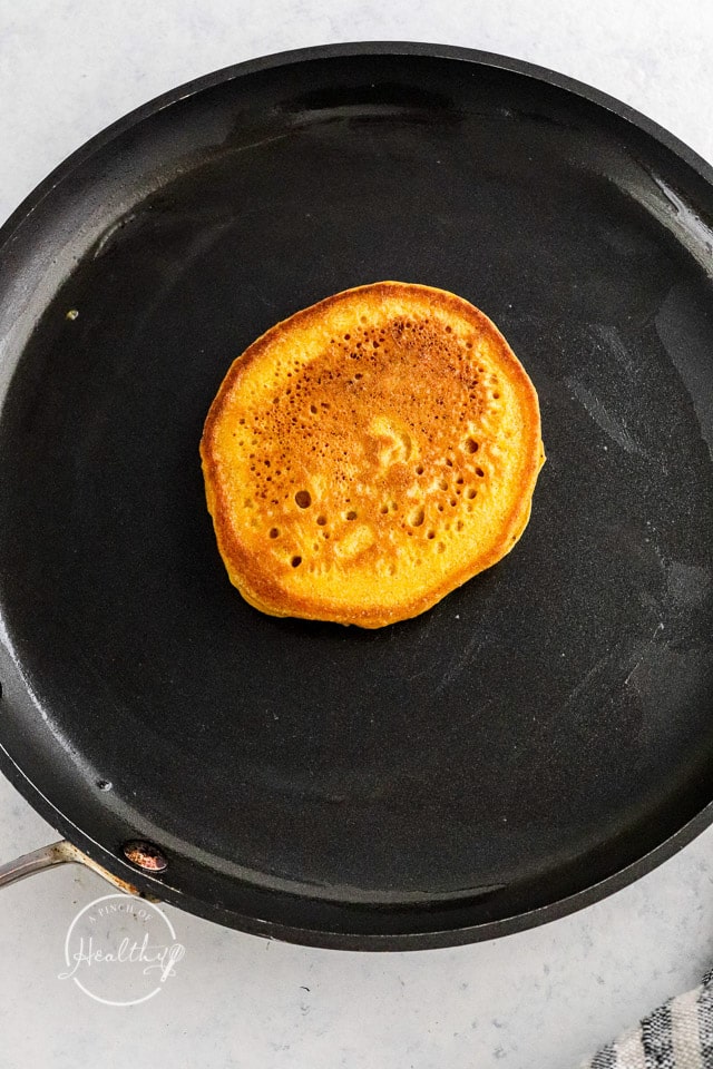cooking pumpkin pancakes in a skillet