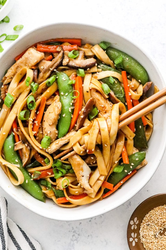 Chicken Lo Mein in a white bowl with chopsticks