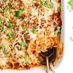 Baked Spaghetti Casserole in white dish with serving spoon
