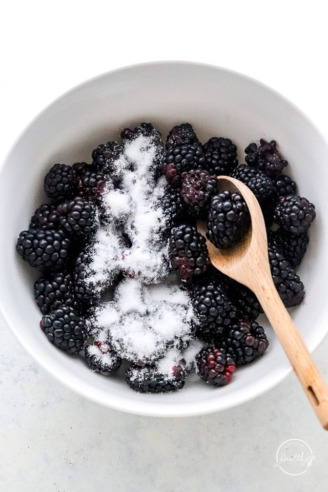 Adding sugar and flour to blackberries