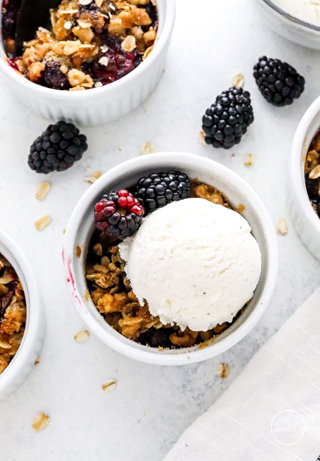 topping blackberry crisp with ice cream