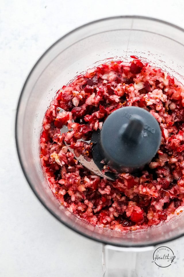 fresh cranberries chopped in food processor bowl without the lid