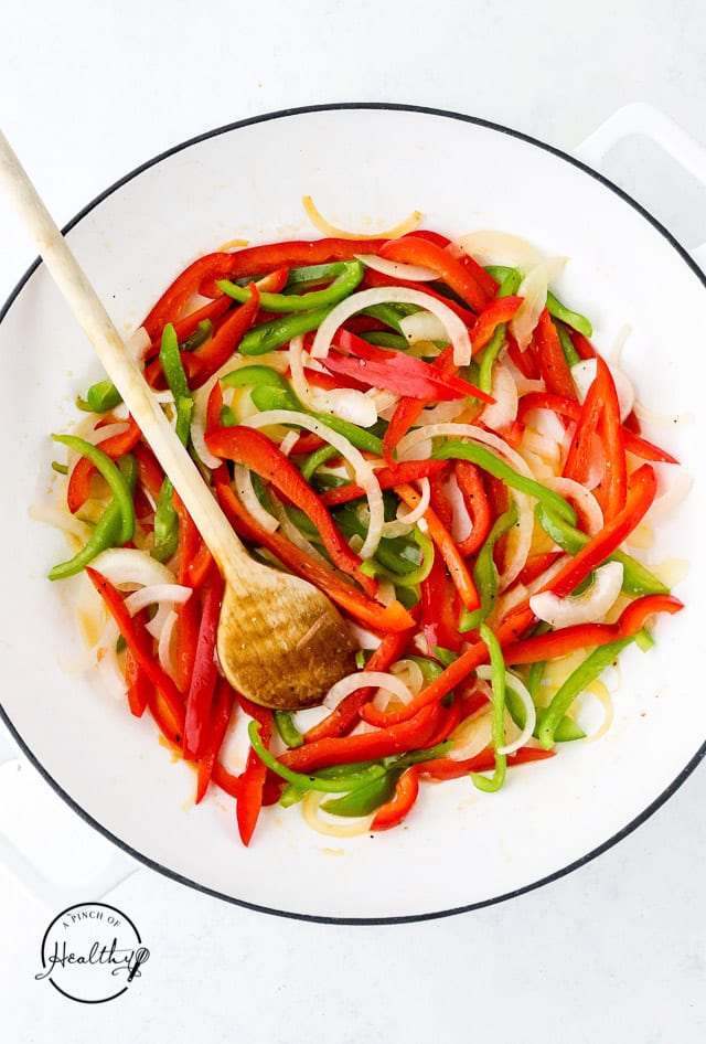 cooking onions and peppers in a skillet
